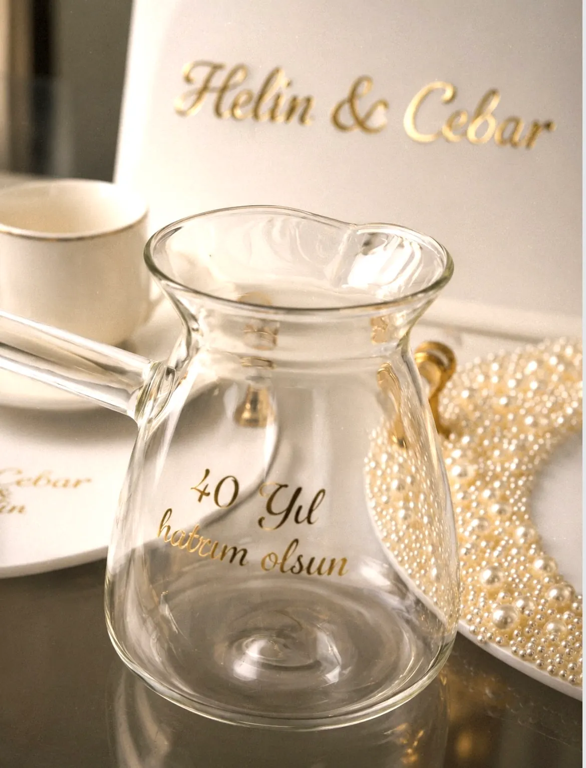 A glass carafe inscribed "40 Yıl hatırım olsun", the couple's names in gold behind it